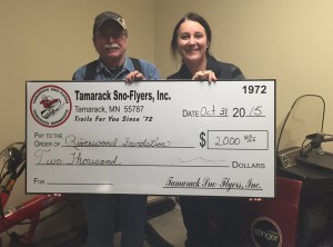 Tamarack Sno-Flyers Board Chair Denny Pepera and Riverwood Foundation Director Katie Nelson